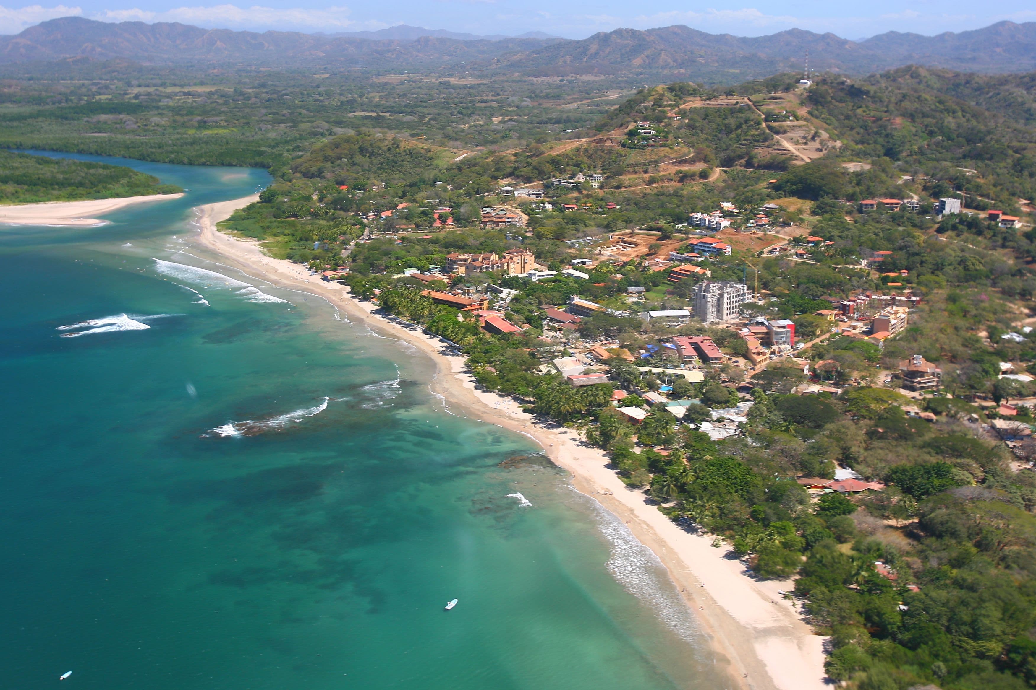 Aerial view of Tamarindo town, beach, and river mouth