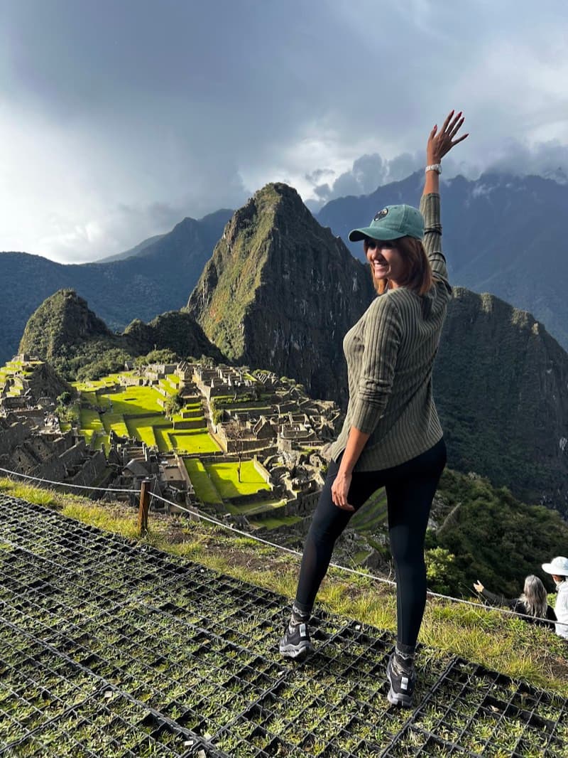 Gaudy waving from a lookout above Machu Picchu, Peru