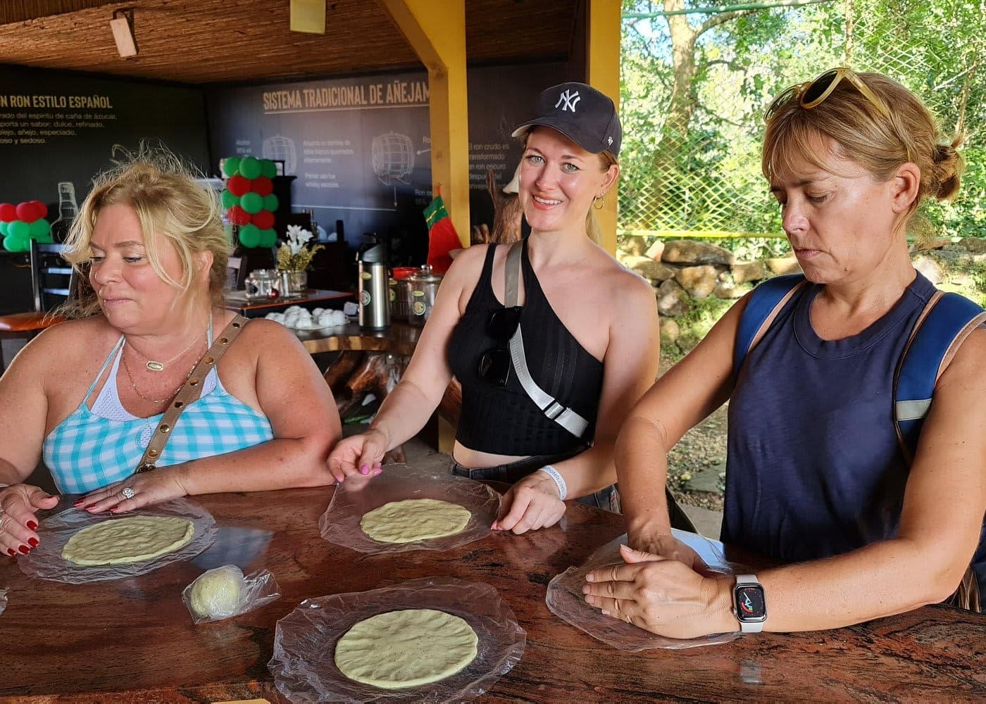 Guests pressing fresh tortillas on a coffee farm tour