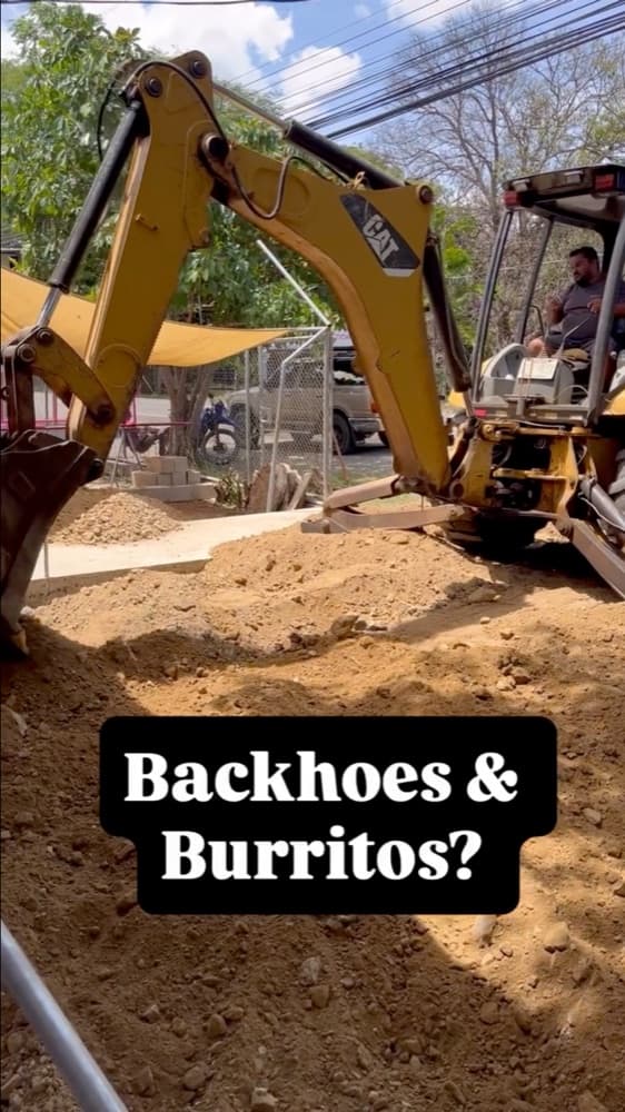 A backhoe digging the lot for the new Gritanga restaurant, with the caption "Backhoes & Burritos?"
