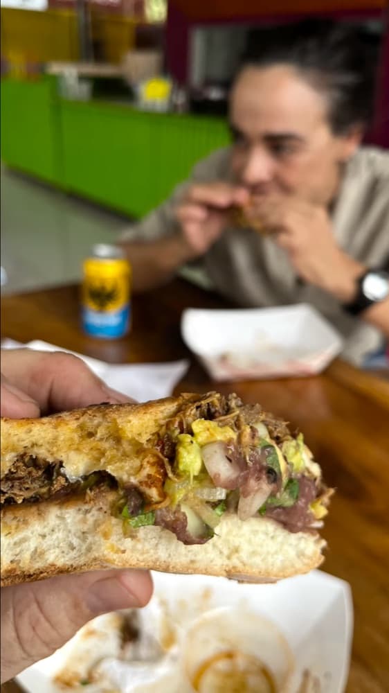 A diner biting into a big burrito at Gritanga