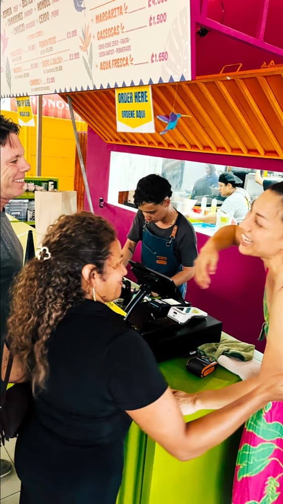 Customers ordering at the bright Gritanga counter in Surfside