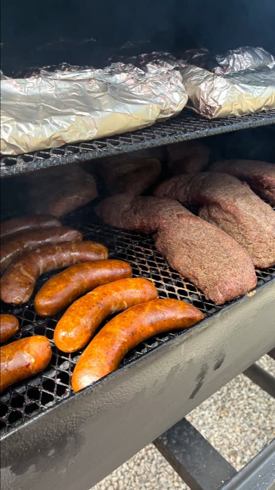 Sausages and meats on the grill at a Gritanga Sunday BBQ